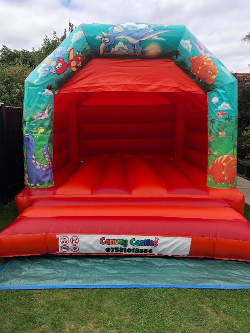 12 x 15ft Orange and Red Medium Children Dinosaurs Bouncy Castle Hire In Essex