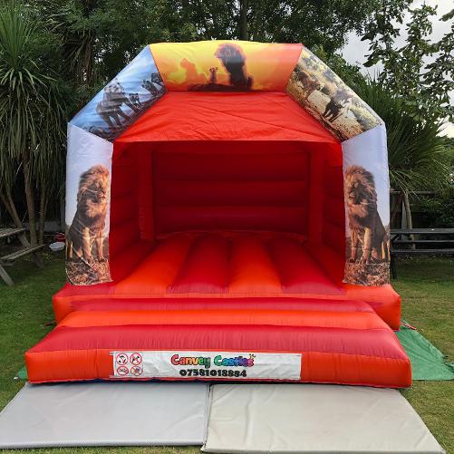 12 x 15ft Medium Red and Orange Lion King Bouncy Castle Hire In Essex